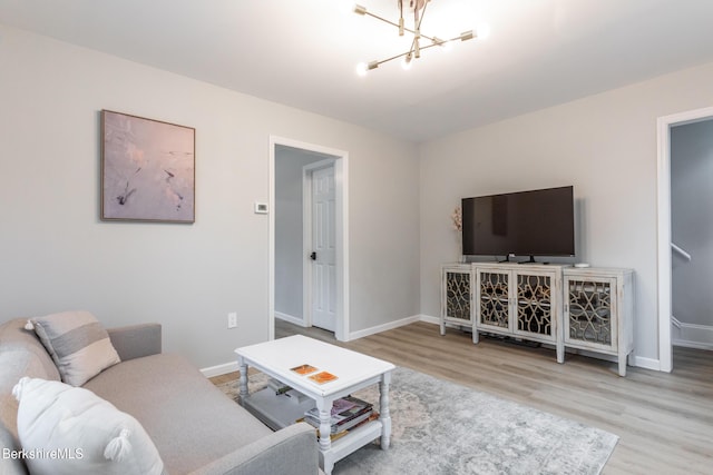 24 Front St Unit 22-24, Williamstown, MA 01267 - living room with wood finished floors, a chandelier, and baseboards