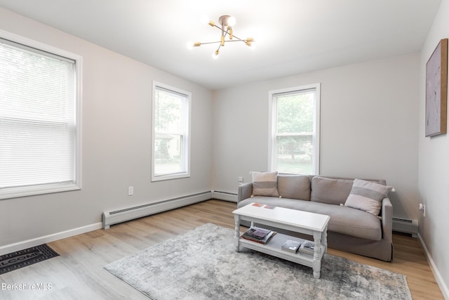 24 Front St Unit 22-24, Williamstown, MA 01267 - living room with a baseboard heating unit, healthy amount of natural light, and a chandelier