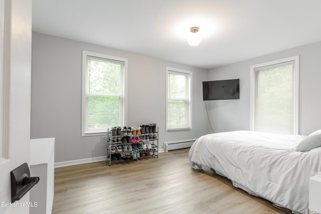 24 Front St Unit 22-24, Williamstown, MA 01267 - bedroom featuring a baseboard heating unit, light wood-style flooring, and baseboards