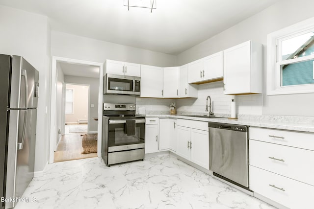 24 Front St Unit 22-24, Williamstown, MA 01267 - kitchen with stainless steel appliances, a sink, tasteful backsplash, and white cabinets