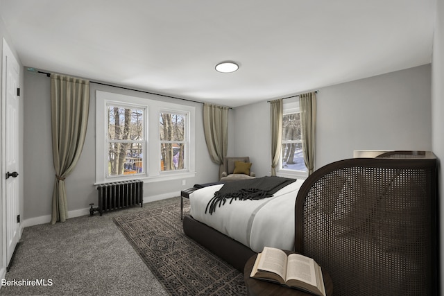 carpeted bedroom featuring multiple windows, radiator, and baseboards