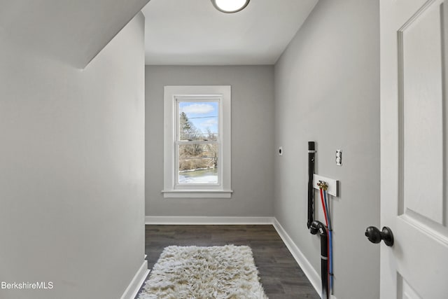 interior space featuring hookup for a washing machine, dark wood-style floors, baseboards, hookup for an electric dryer, and laundry area