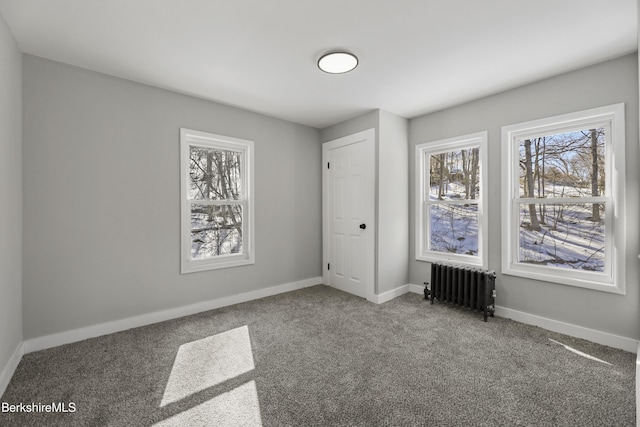 unfurnished bedroom featuring carpet flooring, radiator heating unit, and baseboards