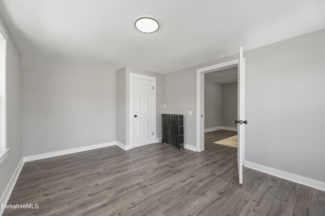 empty room featuring baseboards and wood finished floors