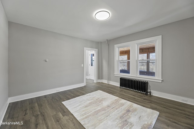 interior space featuring dark wood-style floors, radiator, and baseboards