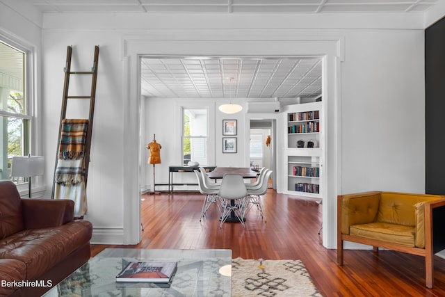 49 S St, Great Barrington, MA 01230 - living area with built in shelves, baseboard heating, and wood finished floors