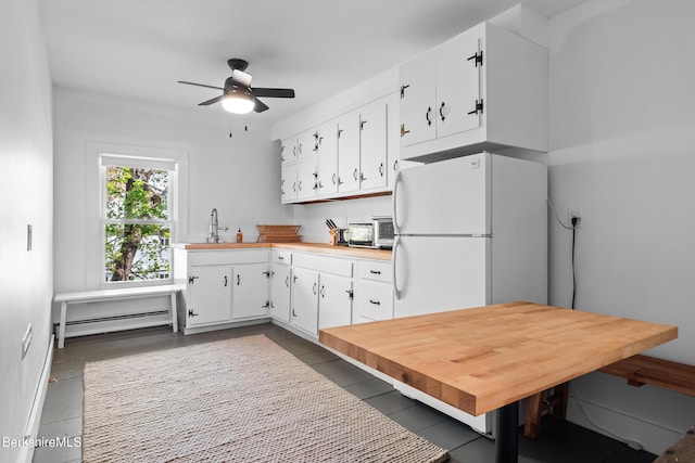 49 S St, Great Barrington, MA 01230 - kitchen featuring freestanding refrigerator, a baseboard radiator, light countertops, white cabinetry, and a ceiling fan