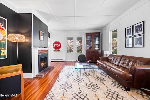 49 S St, Great Barrington, MA 01230 - living area with wood finished floors, a baseboard heating unit, and a fireplace