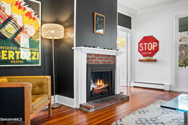 49 S St, Great Barrington, MA 01230 - living room featuring a baseboard heating unit, wood finished floors, and a fireplace
