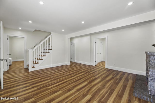 unfurnished living room with dark wood-type flooring