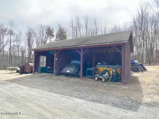 view of parking / parking lot with a carport