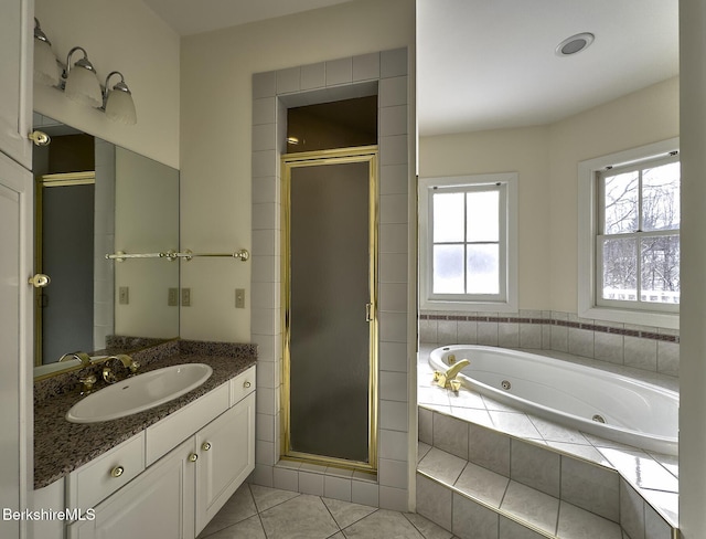 bathroom featuring vanity, separate shower and tub, a wealth of natural light, and tile patterned floors