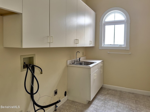 washroom with sink, light tile patterned floors, electric dryer hookup, hookup for a washing machine, and cabinets