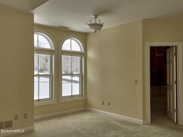 unfurnished room with light carpet