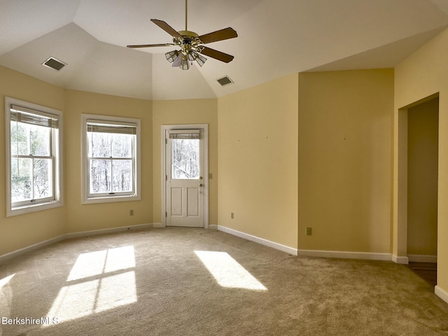 carpeted empty room featuring vaulted ceiling and ceiling fan