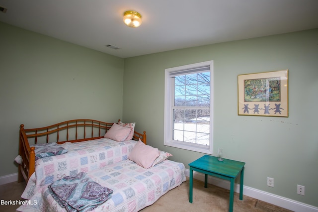 carpeted bedroom with visible vents and baseboards