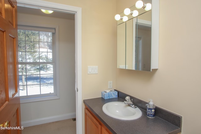 bathroom with baseboards and vanity