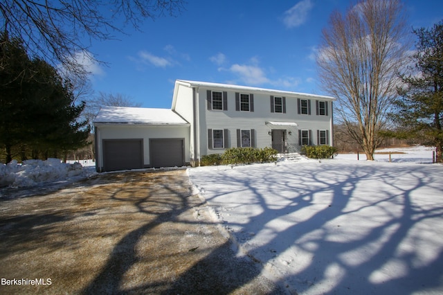 colonial inspired home featuring driveway and an attached garage