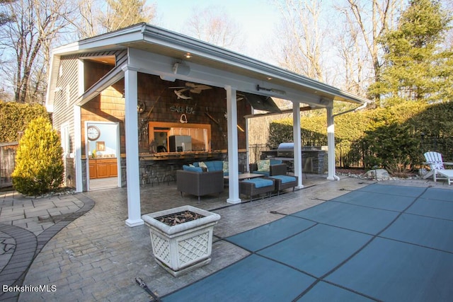 view of patio with ceiling fan, area for grilling, and an outdoor hangout area