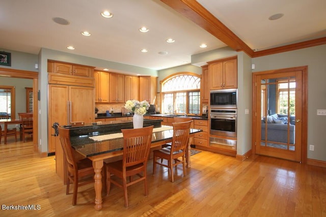 dining space featuring beamed ceiling, light hardwood / wood-style flooring, and crown molding