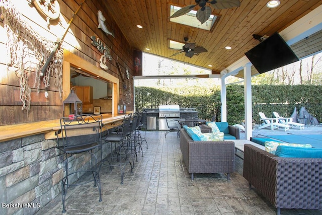 view of patio / terrace with an outdoor hangout area, area for grilling, and an outdoor bar