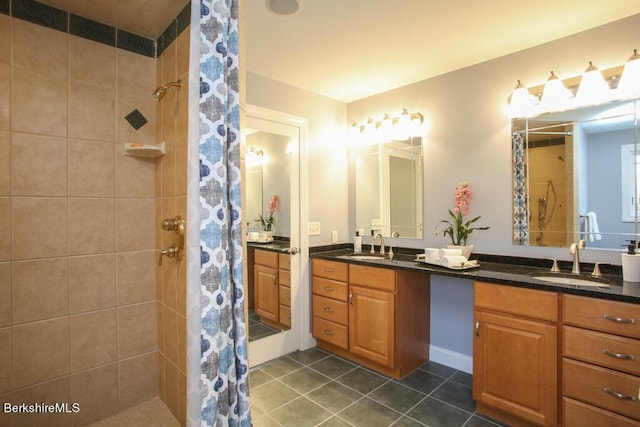 bathroom with a shower with shower curtain, vanity, and tile patterned flooring