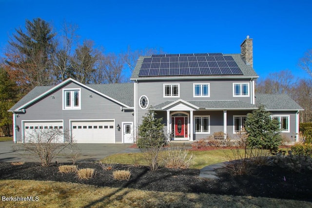 view of front of house featuring solar panels and a garage