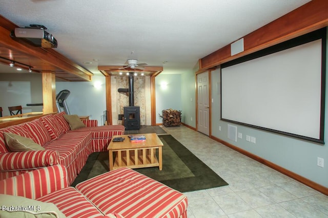 cinema featuring ceiling fan, a wood stove, and rail lighting