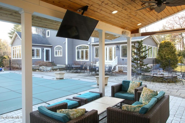 view of patio featuring outdoor lounge area, ceiling fan, and a covered pool