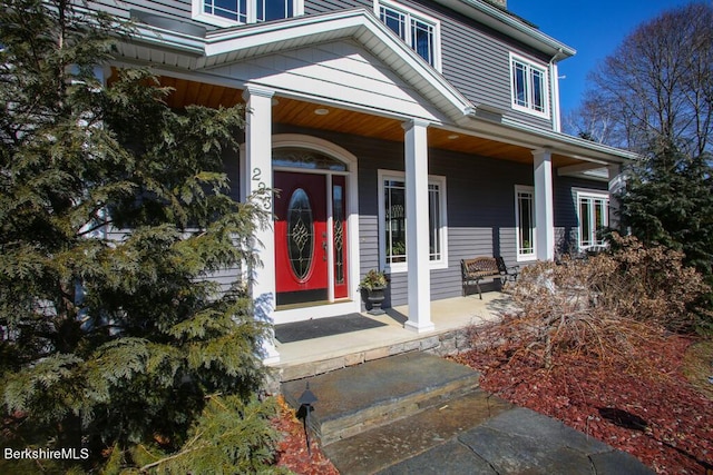 view of exterior entry with a porch