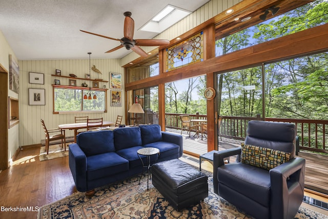 284 Brewer Branch Rd, New Marlborough, MA 01230 - living room with ceiling fan, hardwood / wood-style floors, vaulted ceiling, wooden walls, and baseboards