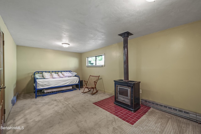 284 Brewer Branch Rd, New Marlborough, MA 01230 - carpeted bedroom featuring a wood stove and a baseboard heating unit