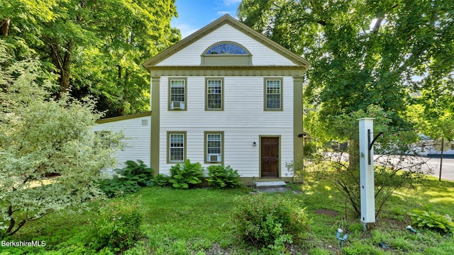 greek revival house featuring a front yard