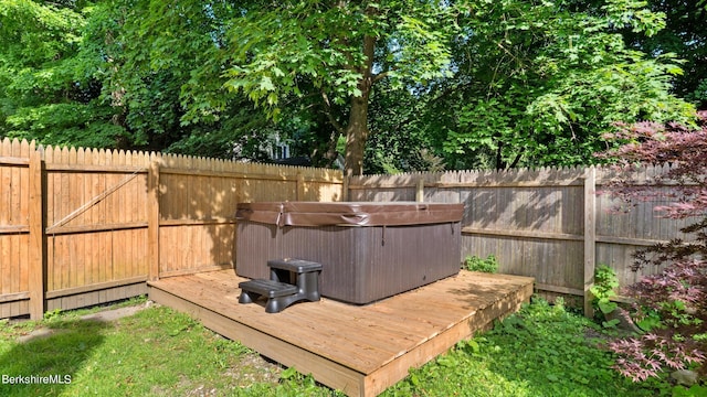 view of yard with a hot tub and a wooden deck