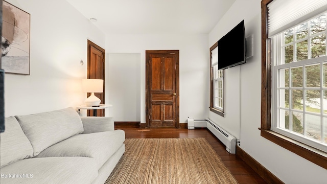 living room with dark hardwood / wood-style flooring and a baseboard radiator