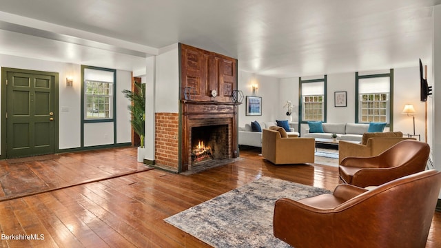 living room featuring a fireplace, hardwood / wood-style flooring, and plenty of natural light