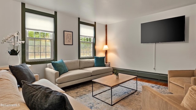 living room featuring wood-type flooring and baseboard heating