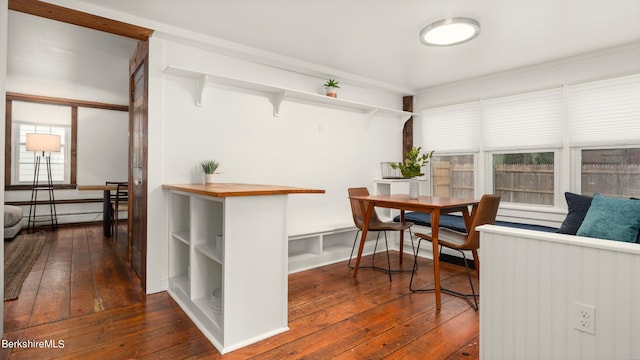 dining room with dark wood-type flooring and a baseboard heating unit