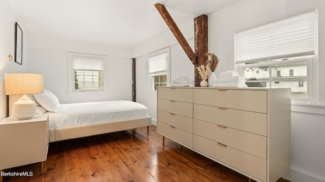 bedroom with dark hardwood / wood-style floors