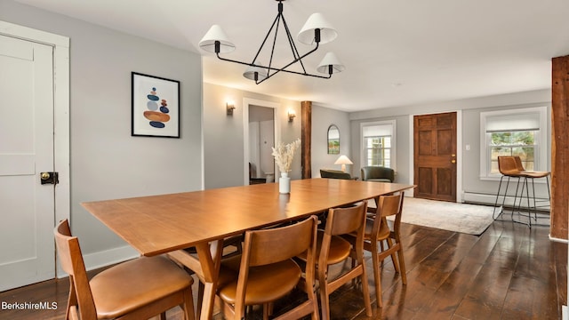 dining area featuring a baseboard radiator, dark hardwood / wood-style floors, and a notable chandelier