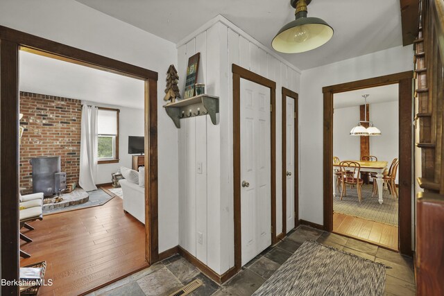 203-205 Main St, Hancock, MA 01237 - entrance foyer with baseboards, dark wood-style flooring, and a wood stove