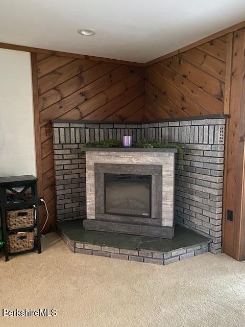 16 Woodlawn Ave, North Adams, MA 01247 - detailed view of carpet flooring, a fireplace, and wooden walls