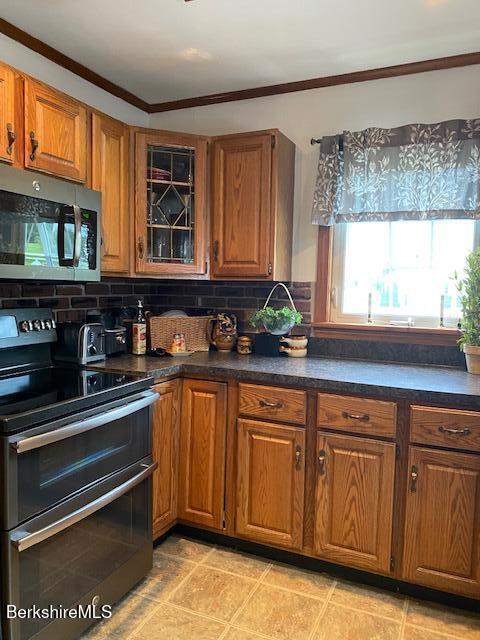 16 Woodlawn Ave, North Adams, MA 01247 - kitchen with stainless steel appliances, brown cabinets, tasteful backsplash, and crown molding