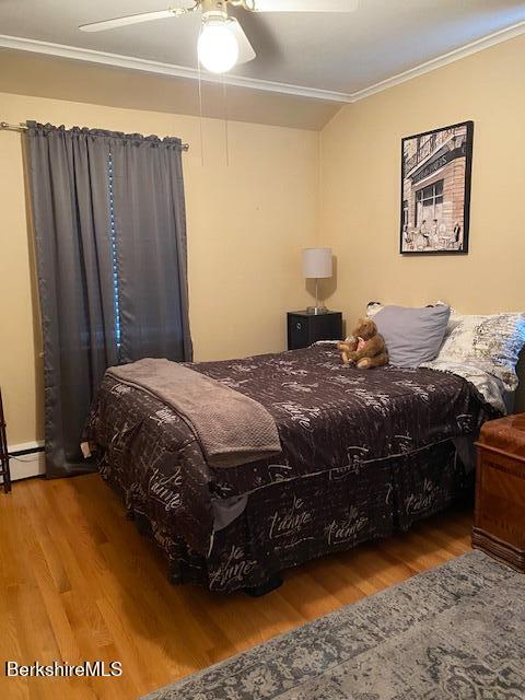16 Woodlawn Ave, North Adams, MA 01247 - bedroom with wood finished floors, ornamental molding, ceiling fan, and a baseboard radiator
