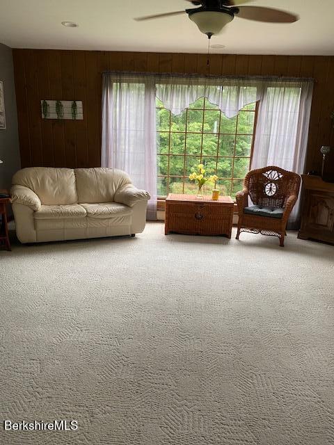 16 Woodlawn Ave, North Adams, MA 01247 - carpeted living area featuring wooden walls and a ceiling fan