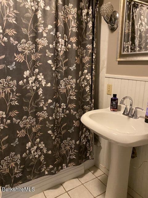 16 Woodlawn Ave, North Adams, MA 01247 - bathroom featuring tile patterned floors, wainscoting, and a shower with shower curtain
