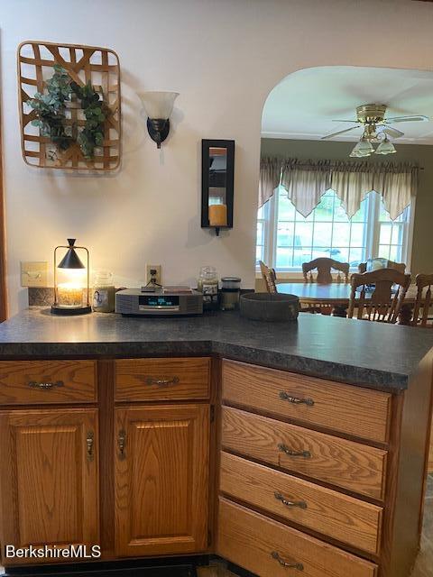 16 Woodlawn Ave, North Adams, MA 01247 - kitchen featuring dark countertops, brown cabinets, and a ceiling fan