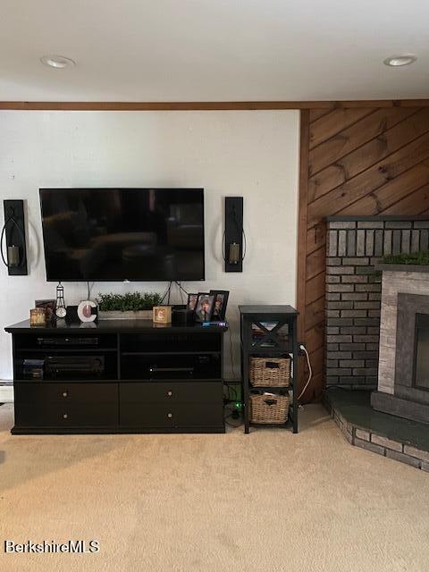 16 Woodlawn Ave, North Adams, MA 01247 - carpeted living room featuring a fireplace and wooden walls