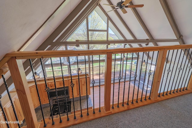 interior space featuring carpet floors, a ceiling fan, and beam ceiling