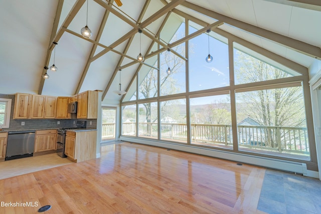 kitchen with appliances with stainless steel finishes, baseboard heating, high vaulted ceiling, backsplash, and beamed ceiling